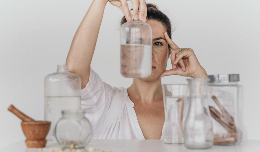 Woman examining water clarity and purity.