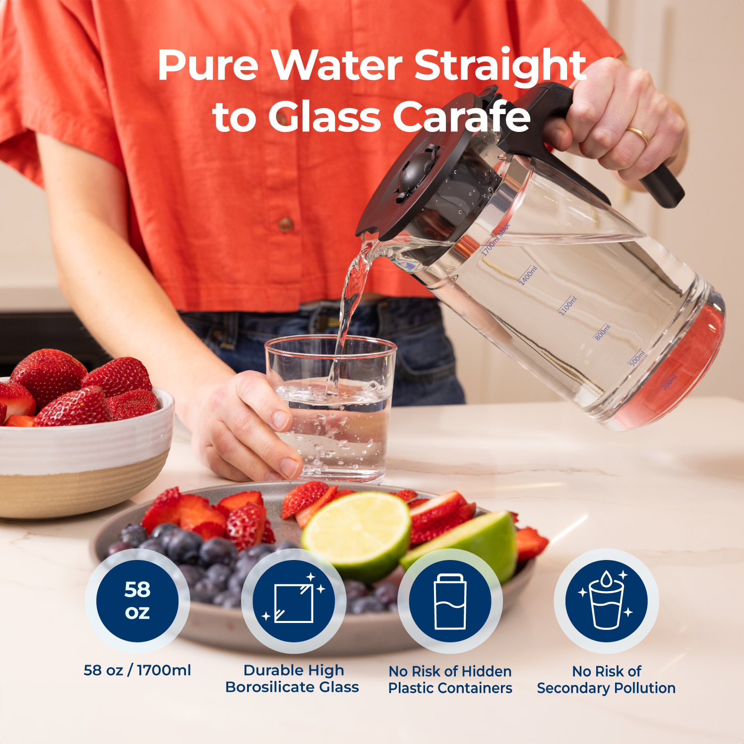 Pouring pure water into glass carafe from Bluevua countertop RO system with fruit nearby.